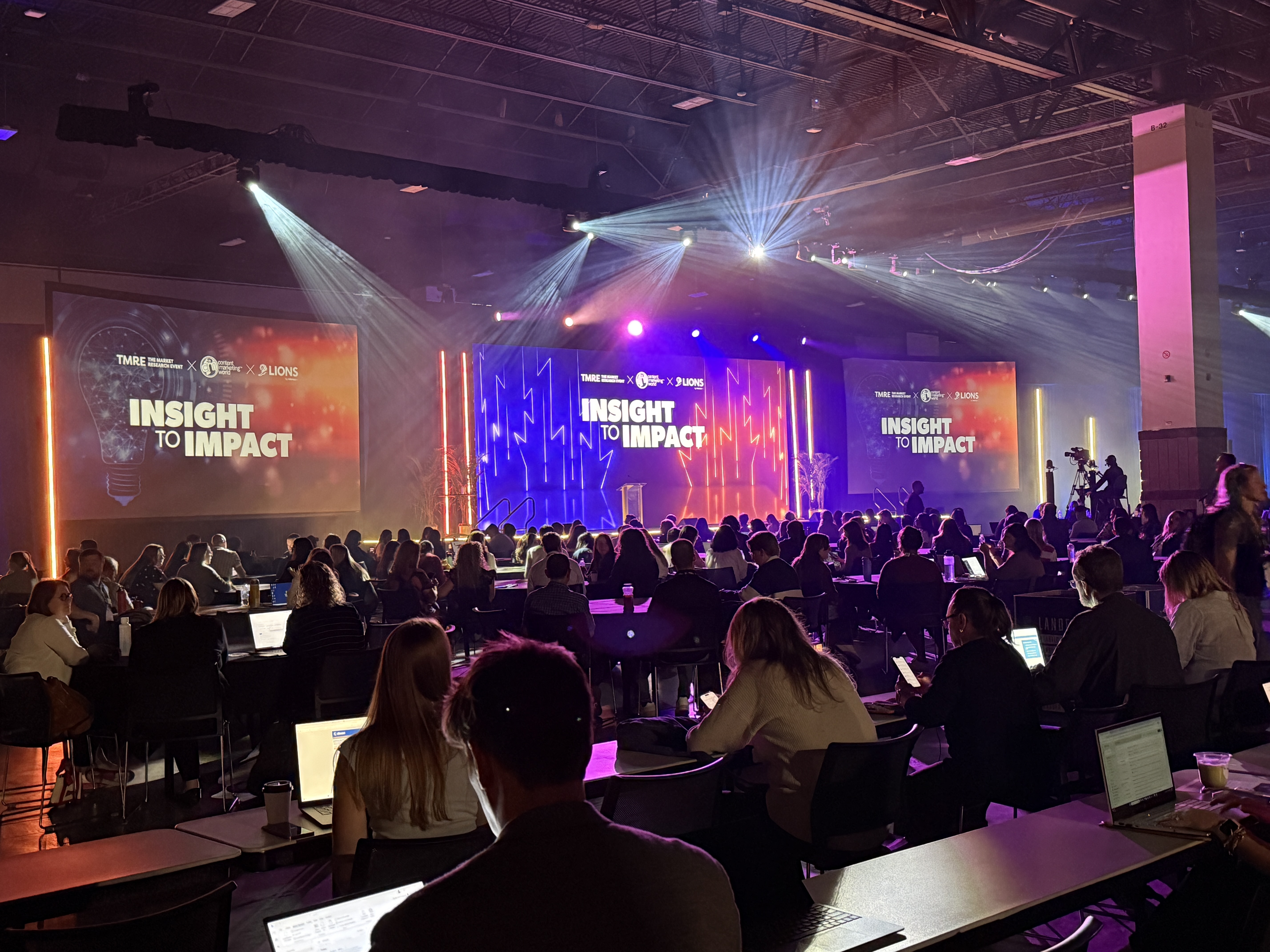 A crowd seated in front of a stage at Content Marketing World, with 